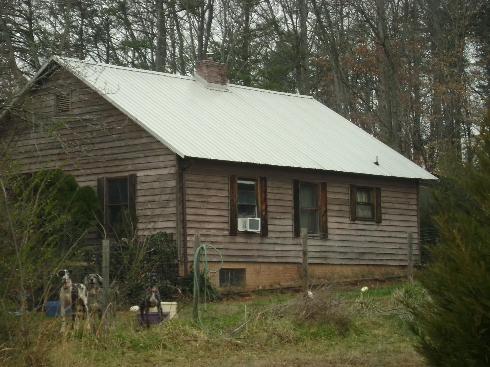 White metal roof on an old wood sided farmhouse, from a Metal Roof Installation job in Montpelier
